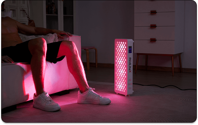 A man using infrared light therapy to relieve knee pain