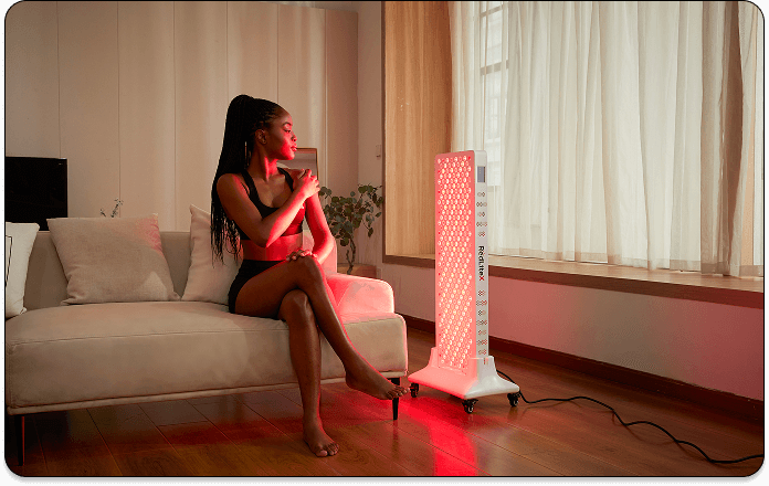 A woman using infrared light therapy to combat aging